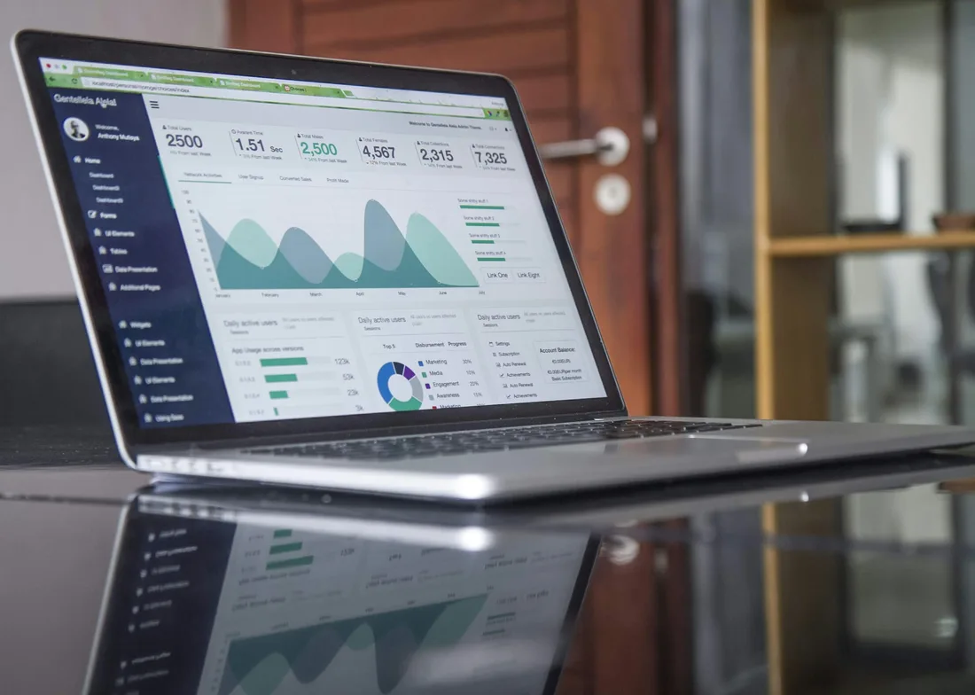 Laptop displaying an analytics dashboard with charts and metrics